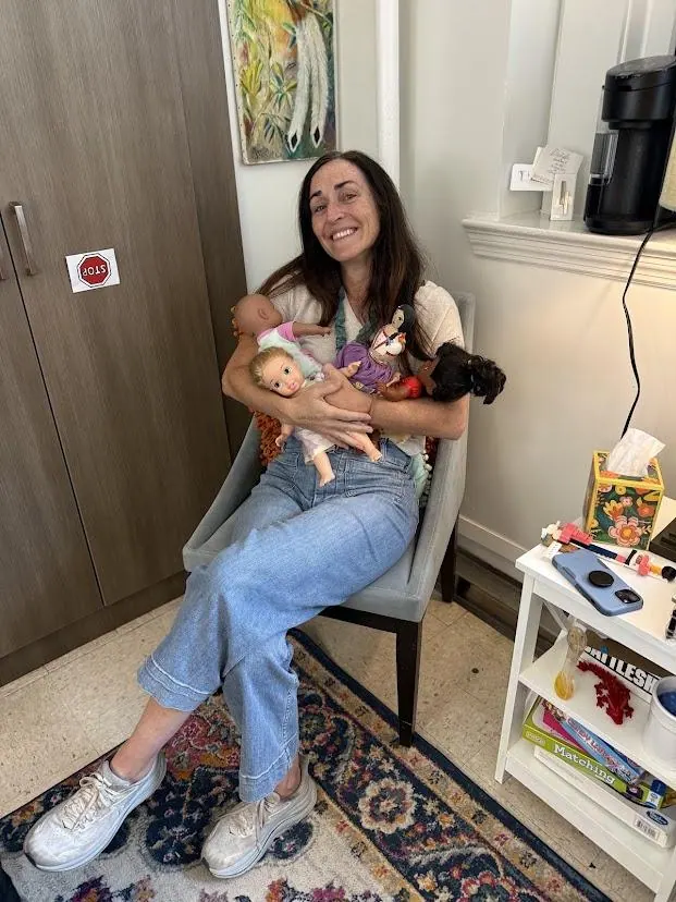 An adult seated with a dog
