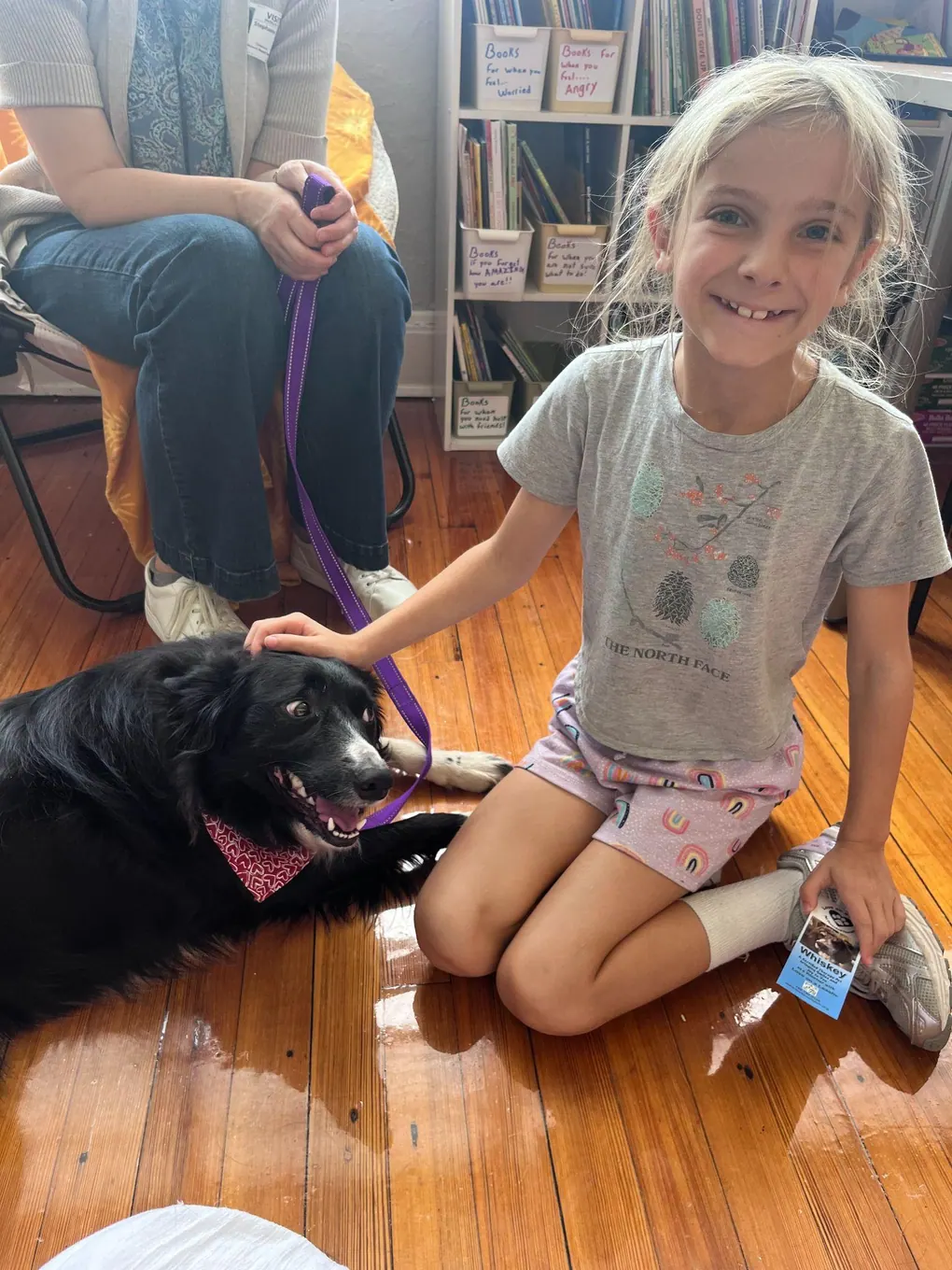 A student beside a dog
